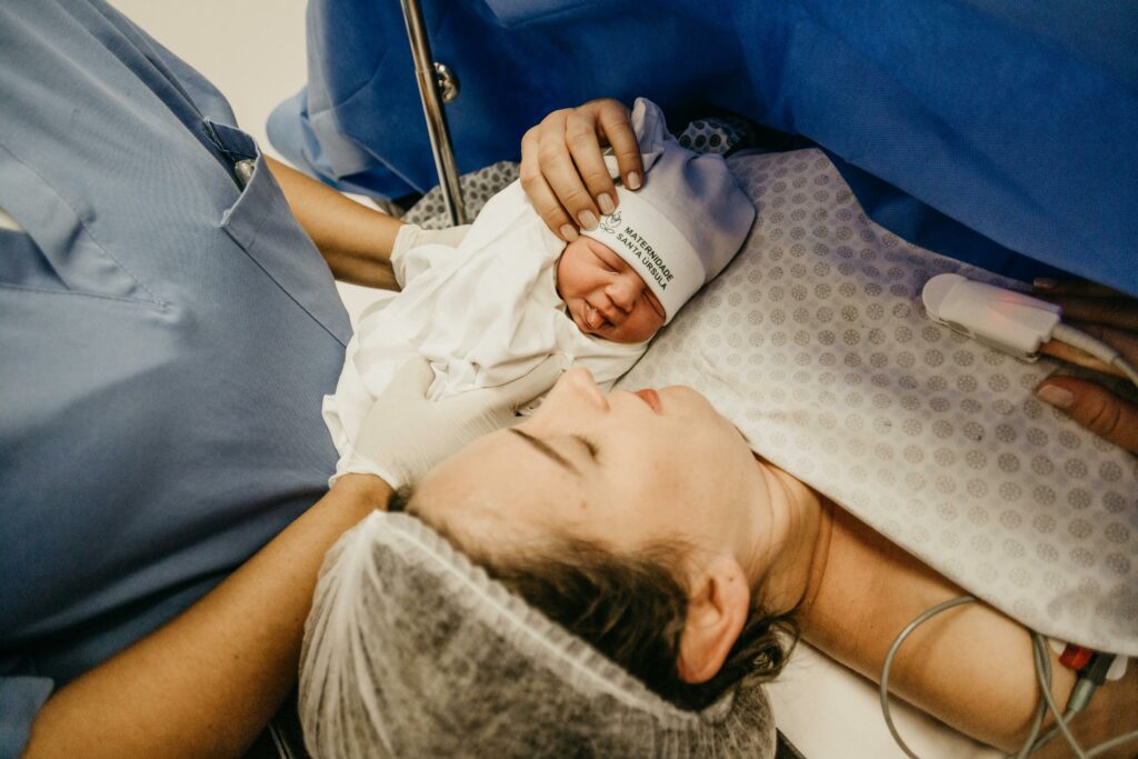 mother in operating theater after csection meeting her newborn